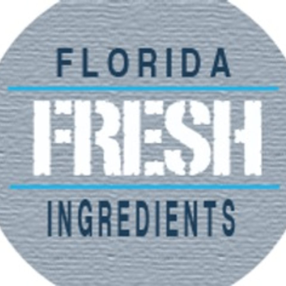 Circular logo with "FLORIDA FRESH INGREDIENTS" in blue and white text on a textured gray background.